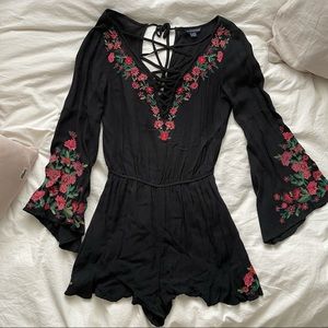 black floral romper with lace up detail